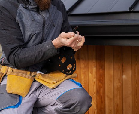 Gutter system being installed on a residential home for optimal water drainage.