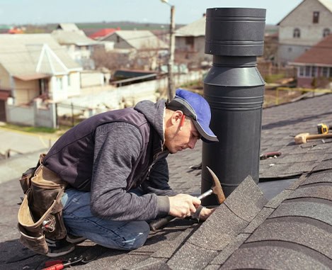 BlueSky roofing crew performing chimney repair on an asphalt shingle roof in Clifton NJ