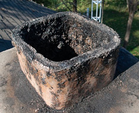 Damaged chimney flue on roof; chimney repair needed in New Jersey.