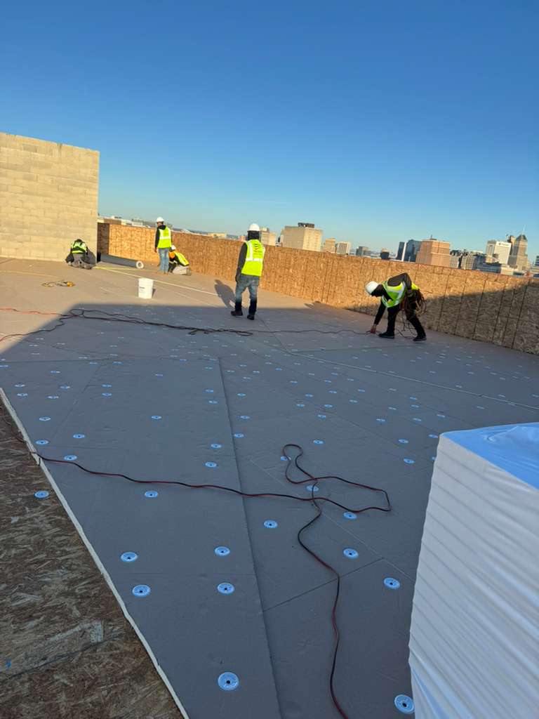 BlueSky roofing crew performing roof replacement on a flat NJ rooftop