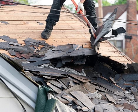 Roof replacement underway; damaged shingles being removed from a New Jersey home.