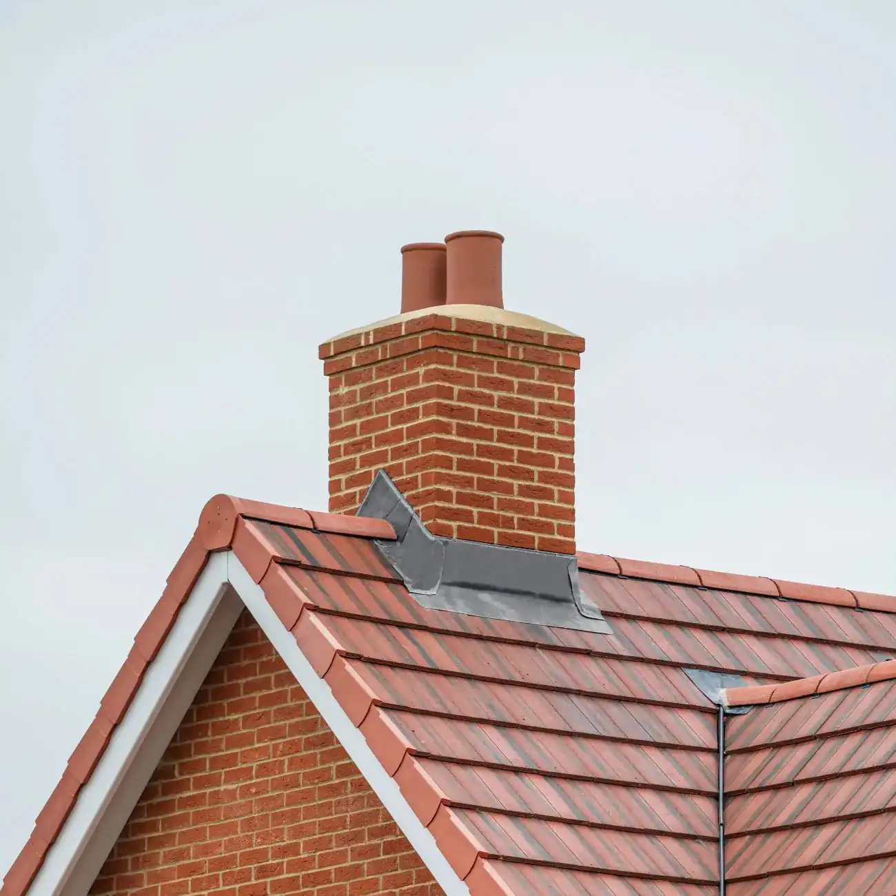 Brick chimney on a residential home in Ridgewood requiring chimney repair, masonry restoration, or chimney inspection