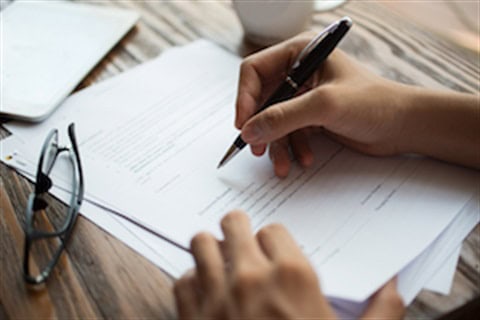 Person signing roofing permit documents for roof replacement in Paramus NJ