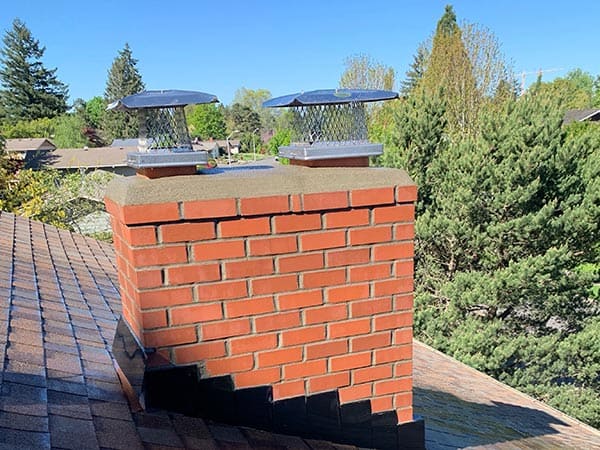 Completed chimney rebuild on a residential home in New Jersey, showcasing restored brickwork, improved structural integrity, and professional masonry craftsmanship.