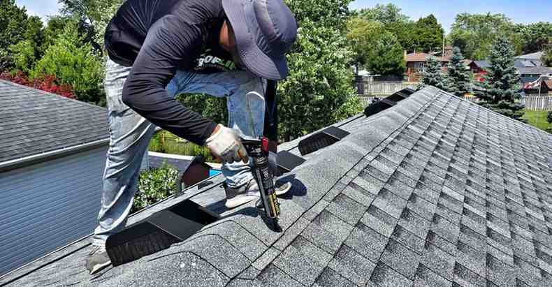 BlueSky roofing crew sealing vents on gray asphalt shingles in New Jersey