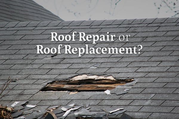Damaged asphalt roof with a large hole and missing shingles before roof replacement in Clifton NJ