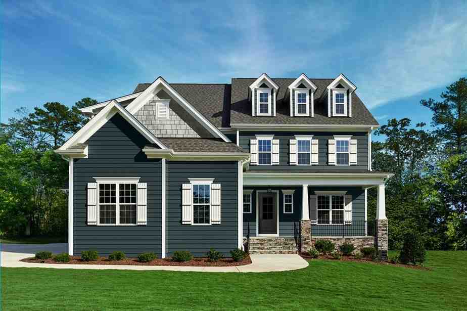 Blue siding installation on a two-story home with dormers, white trim, and front porch, New Jersey