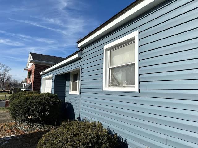 Blue vinyl siding installation on a residential home in Hackensack, NJ for siding replacement guide