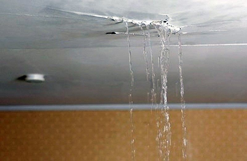 Ceiling leak with dripping water from the roof, indicating roof leak repair in NJ.