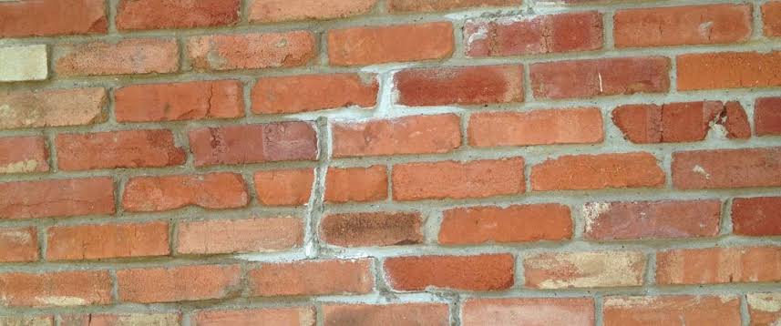 Cracked brick wall with deteriorating mortar, masonry repair in New Jersey