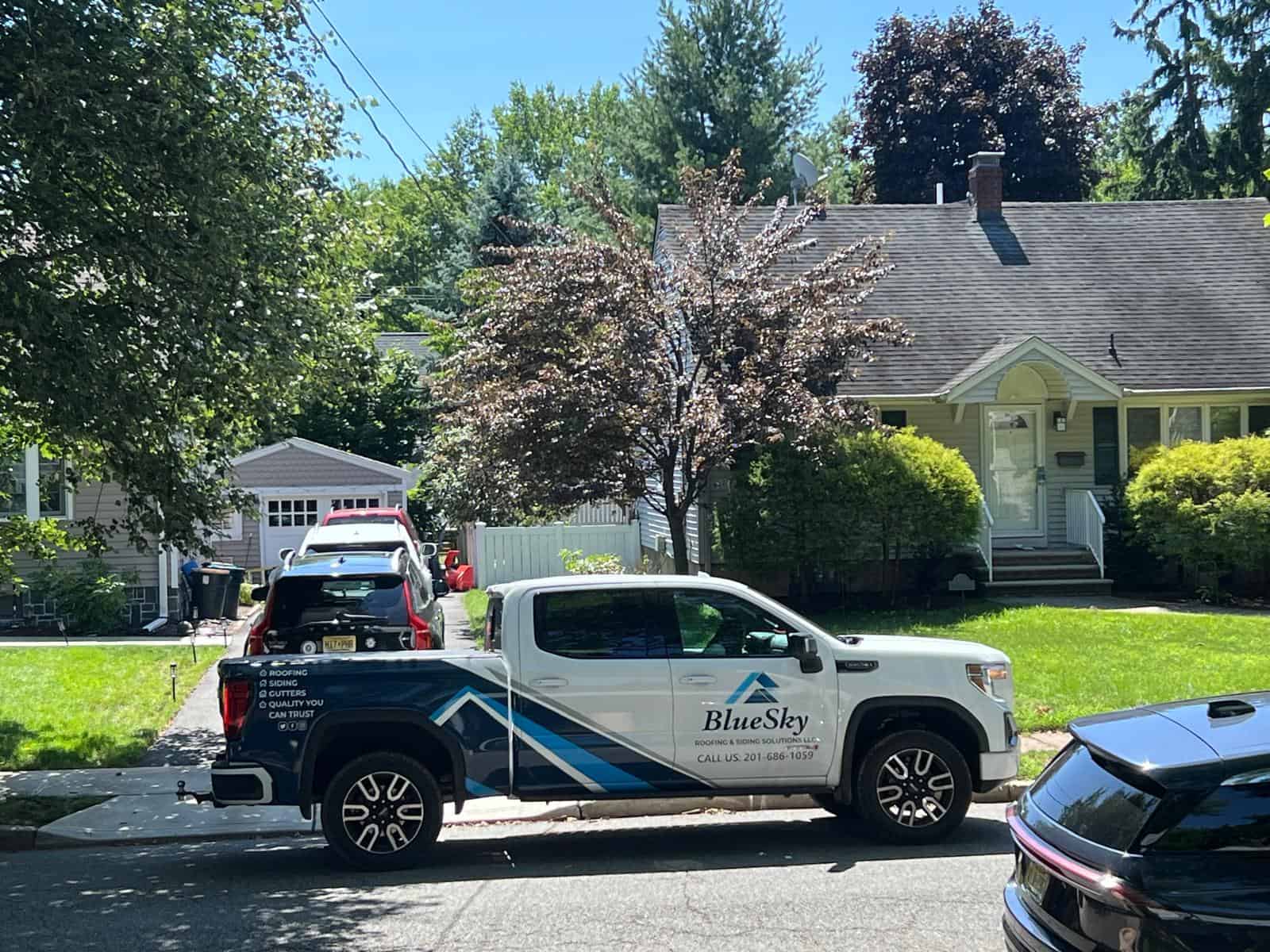 BlueSky roofing truck parked on a residential Clifton NJ street.