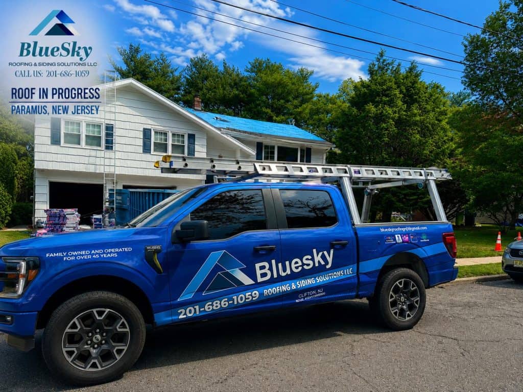 BlueSky Roofing truck with ladder rack in front of a white house; roof replacement in progress in Paramus, NJ.