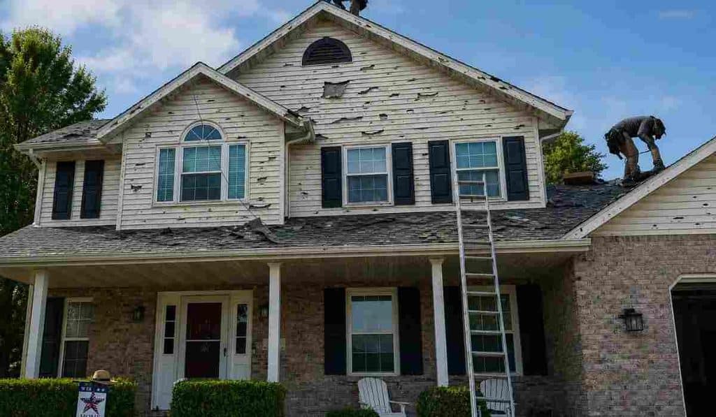 BlueSky roofing crew performing roof leak repair on damaged shingles on a two-story home in New Jersey